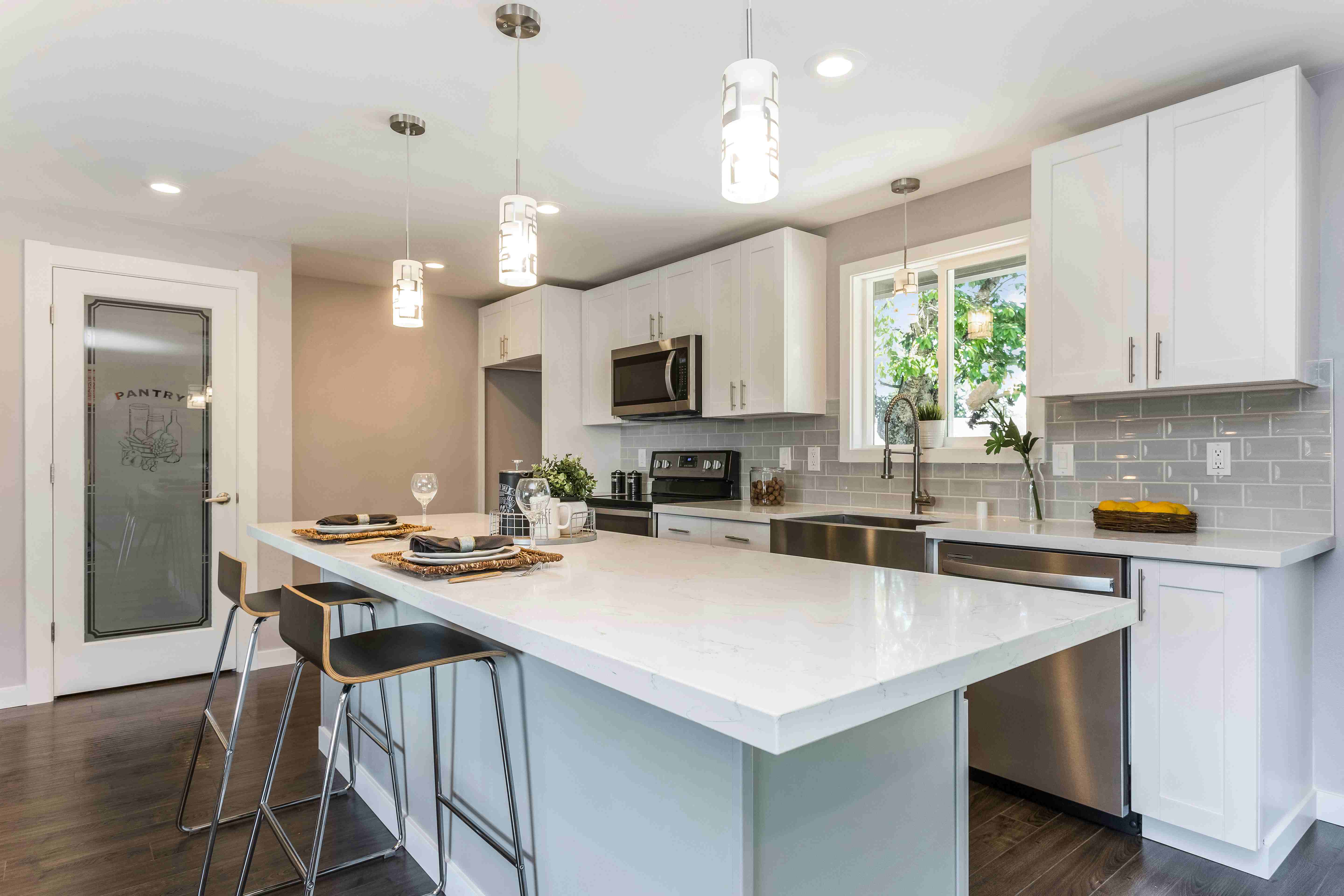 Glass pantry doors bringing light to kitchen space